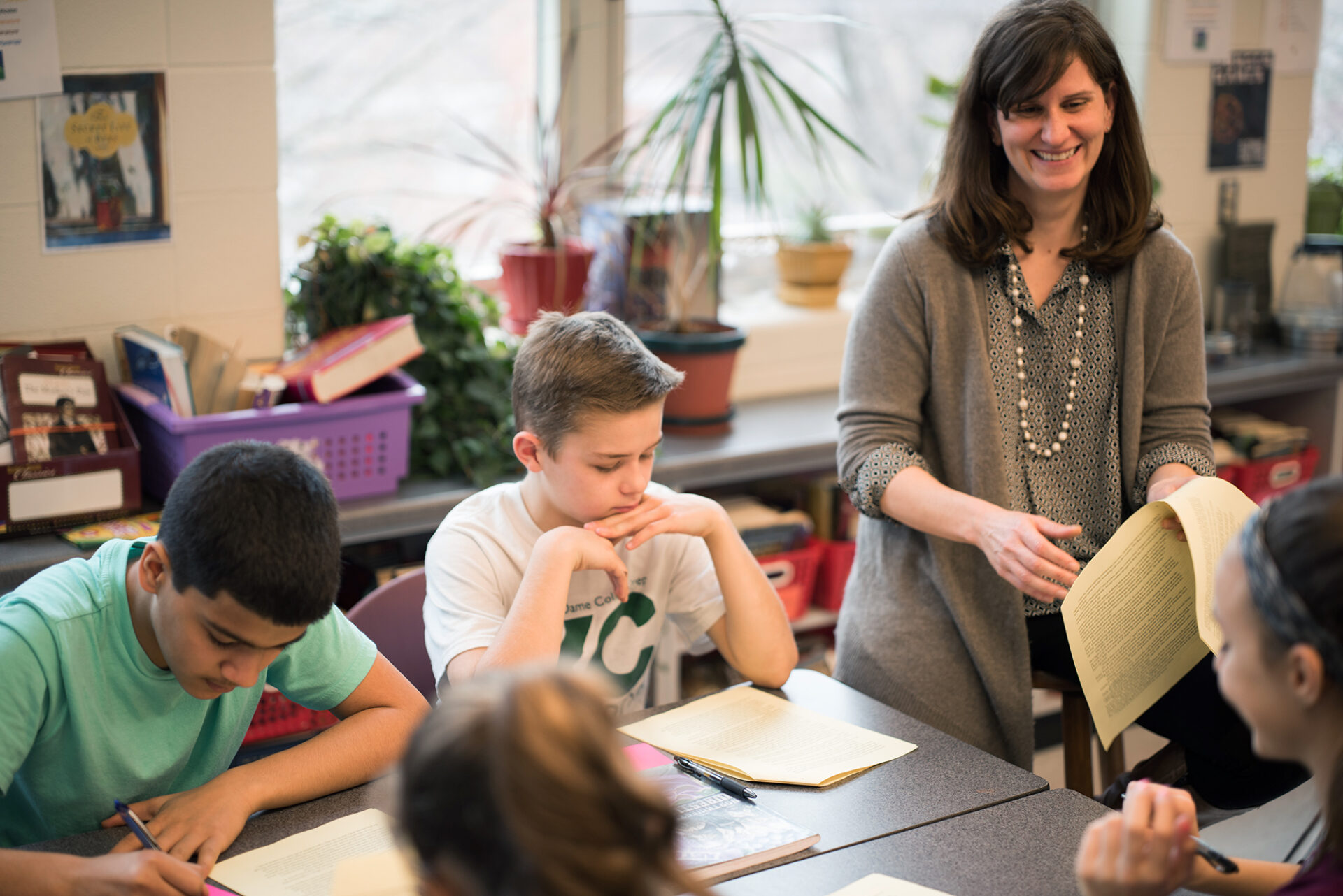 elementary teacher in classroom laughing with students
