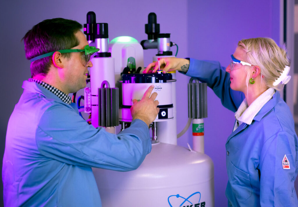 student and instructor in a lab conducting an experiment