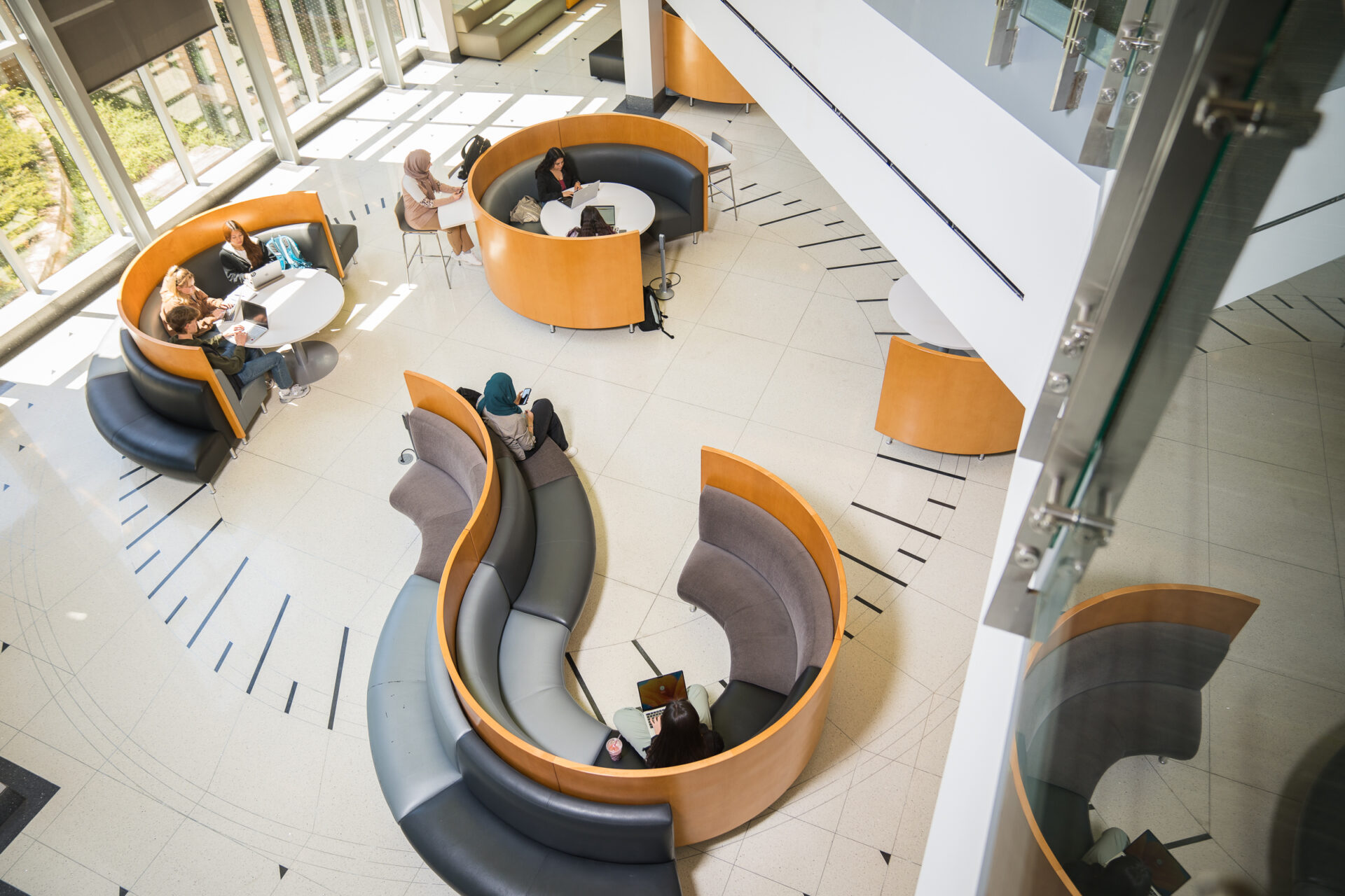 Johnson Center lobby, students studying in booths in a bright lobby