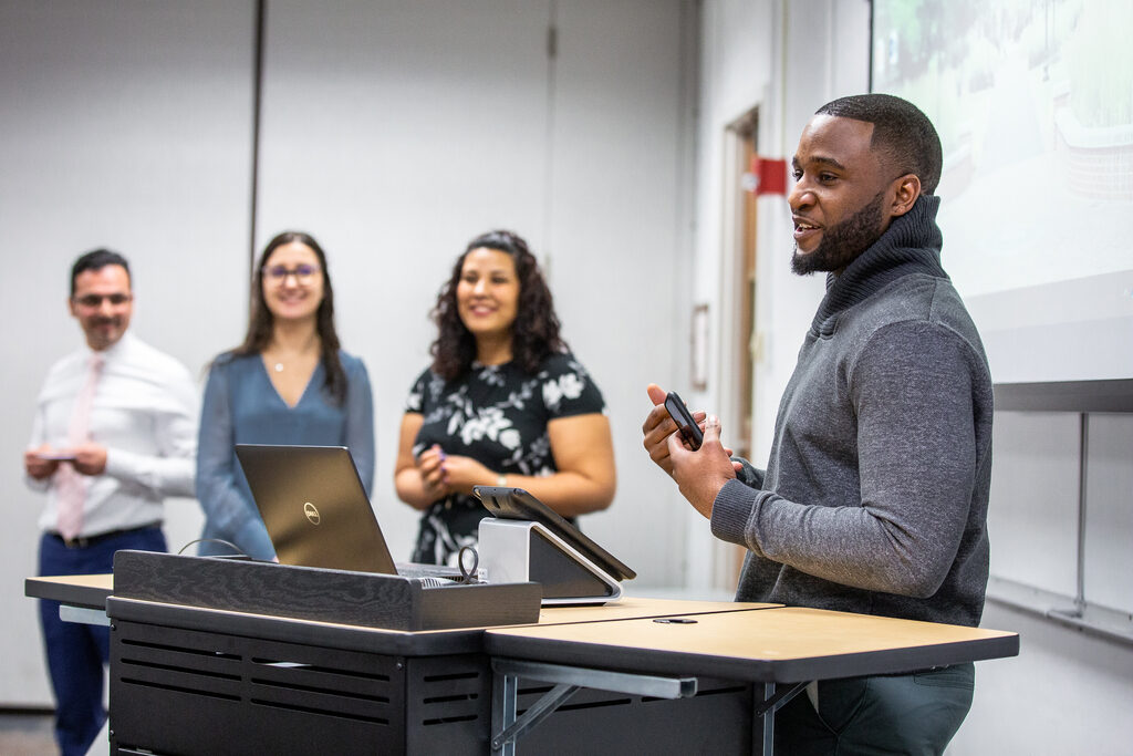 business student presenting to fellow students in classroom