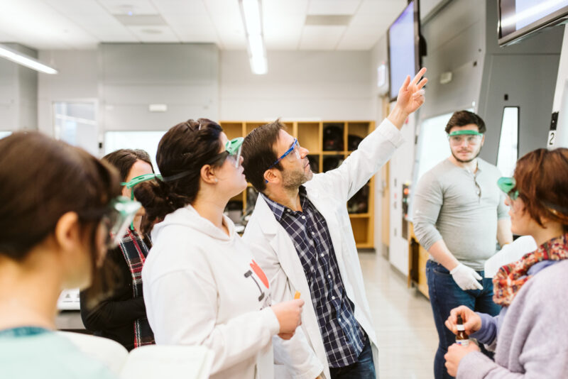 instructor teaching students in a science lab